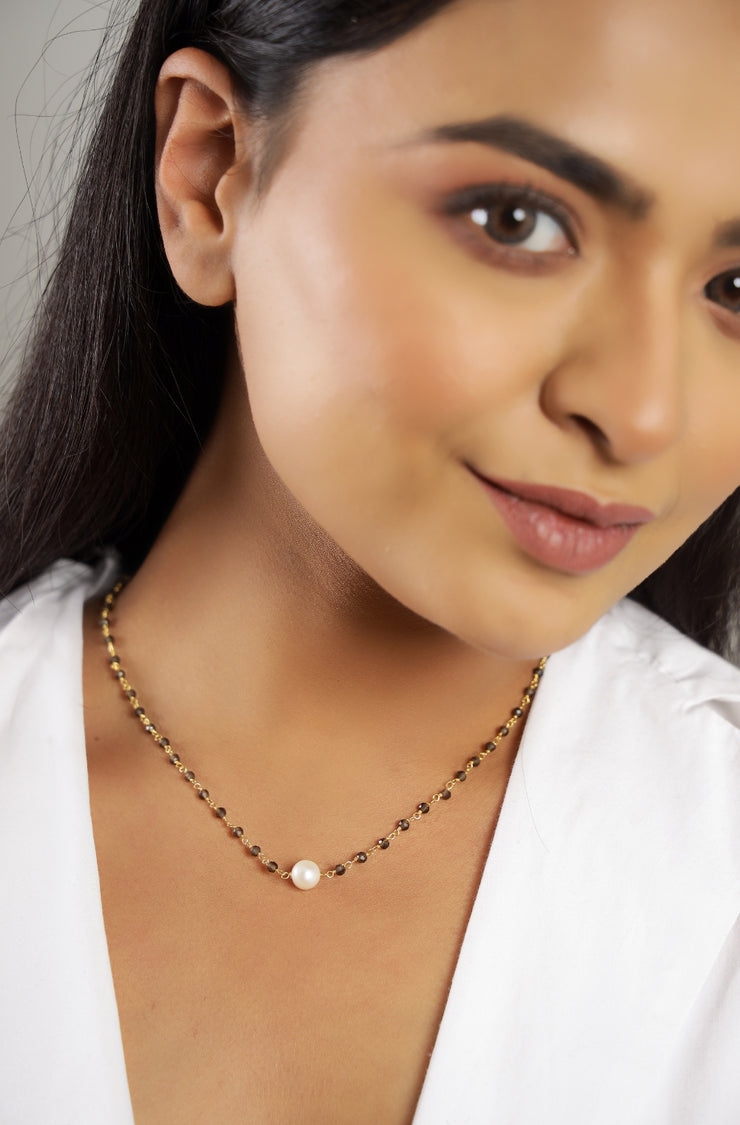 Pure silver with 18k gold plating with pearl in center and blue sapphire stone chain